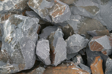 Basalt. Fancy patterns on the rocks. The texture of the stone. Severoonezhsky basalt mine. Arkhangelsk region, Russia.