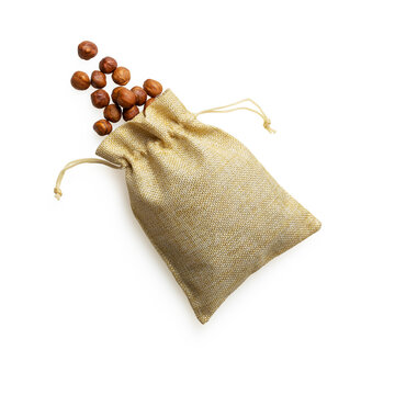 Isolated hazelnuts in a craft bag on white background