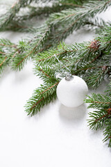 White  holiday decoration on green branch Christmas concept