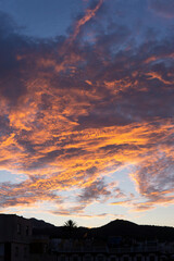 Cloudy sky at sunset with red, orange and blue colors