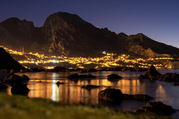 Night landscape of a village located between the coast and a mountain