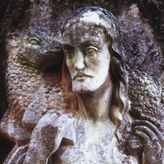 Fototapeta na wymiar Jesus Christ is the Good Shepherd. Close up fragment of an ancient statue.