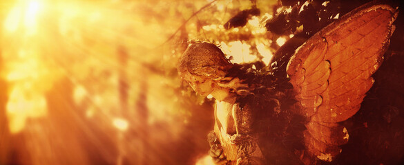 Angel in the sunlight (antique statue) (retro styled image)