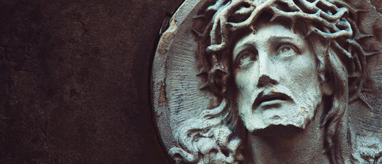 Jesus Christ in a crown of thorns (fragment of ancient statue). Copy space for text or design.
