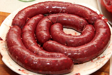 Freshly stuffed pork intestines with blood sausage mass. Organic blood sausage. Homemade sausages
