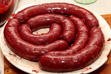 Freshly stuffed pork intestines with blood sausage mass. Organic blood sausage. Homemade sausages