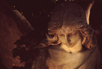 Angel in the sunlight. Antique statue. Fragment.