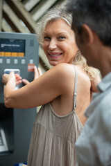 mature couple making payment at outdoor machine