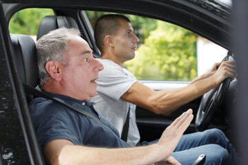 men during moment of car accident inside of a car