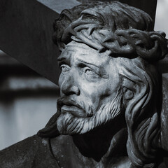 Crucifixion of Jesus Сhrist. Close up fragment of an ancient statue.