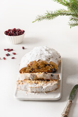 Christmas stollen traditional festive German bread on a white background. Xmas holiday fruitcake. Christstollen. Vertical format.