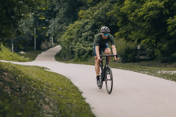 Fototapeta premium Caucasian man cycling at park during morning time