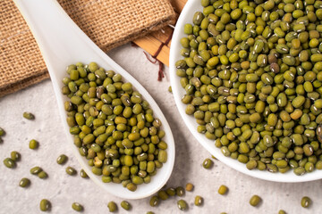 Raw mung bean on wooden table background.
