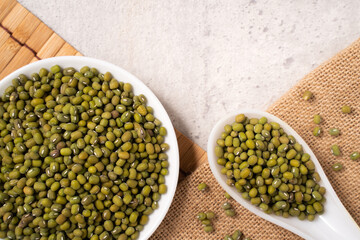Raw mung bean on wooden table background.