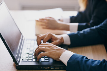 colleagues sitting in front of a laptop teamwork internet officials