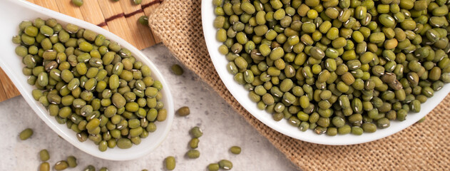 Raw mung bean on wooden table background.