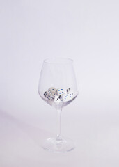 dices in a wine glass on a white background.minimal still life abstract design
