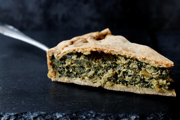 Piece of chard leaves stuffed pie. Swiss chard homemade baked food.