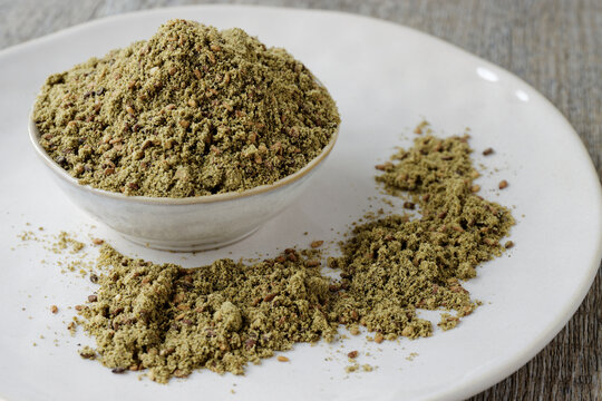 Green Za'atar spice blend heap in a bowl. Traditional Middle East zaatar condiment.