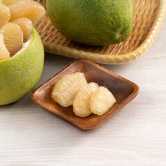 Fresh pomelo fruit on wooden table background.