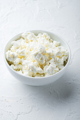 Cottage cheese or curd, on white textured background