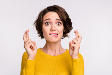 Photo of young girl worried nervous bite lips teeth crossed fingers beg wish luck isolated over...