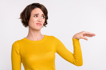 Photo of dislike brunette millennial lady look empty space wear yellow shirt isolated on grey color...