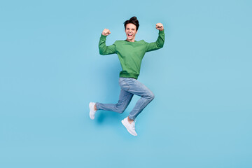 Fototapeta na wymiar Full length body size photo guy jumping up showing strong hands isolated pastel blue color background