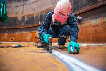 Male worker test steel tank butt weld carbon bottom plate of storage tank oil magnetic field © chitsanupong