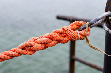 Marine rope. Synthetic rope fence. Metal carabiner. Cable. Knot.