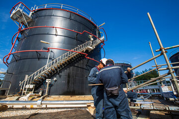 Male worker inspection visual pipeline storage tank crude oil