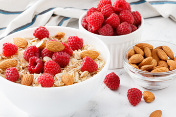 bowl of oatmeal with raspberries and almonds