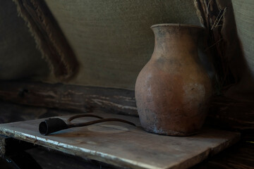 an old pot of clay on an old wooden table.