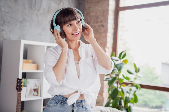 Portrait of attractive cheerful girl listening different pop rock soul bass spending free time at home loft brick interior indoors