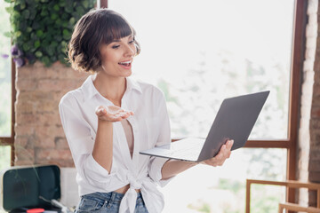 Portrait of attractive trendy cheerful girl using laptop video call explaining plan idea project at...