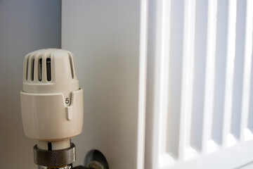 Thermostatic valve on radiator turned to highest number 5, close up - obrazy, fototapety, plakaty