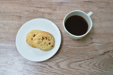 mixed nut cookie and black coffee cup on table