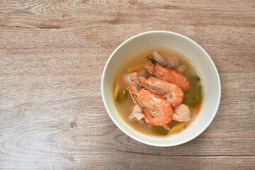 boiled river shrimp with herb in Thai spicy soup or tom yum kung on bowl
