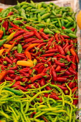 Mix of chili peppers, bell peppers, capi color assortment on vegetable market.