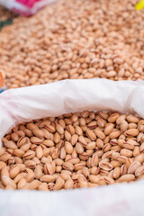 Pistachio in bag in Turkish market. Selected roasted and raw nuts in scarlup.