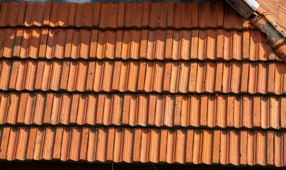 Obraz na płótnie Canvas roof tile. tile roof of a old house. tile roofs used in old and modern style construction for safety and also it keeps house cool inside
