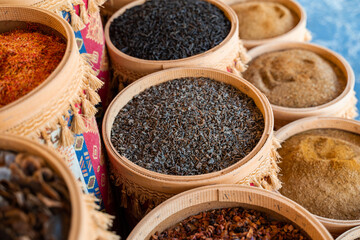 Assortment of Turkish spices and herbs in wooden bowls. Turkish market spices such as saffron, sumac and thyme. Cumin, rosemary and isot.