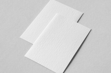 Textured business card mockup, vertical orientation. 55x85 mm.