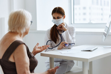 Fototapeta premium elderly woman patient communicates with the doctor health care