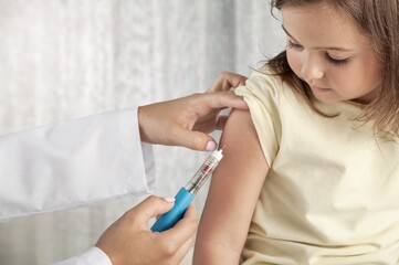 Young patient visits a skillful doctor at hospital for vaccination . Covid 19 and coronavirus vaccination