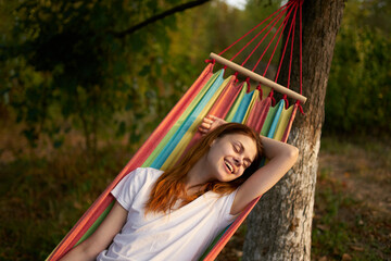 Fototapeta premium woman outdoors lies in a hammock vacation summer