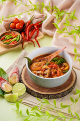 Tom yum or tom yam is a type of hot and sour Thai soup, usually cooked with shrimp (prawn). Tom yum has its origin in Thailand.