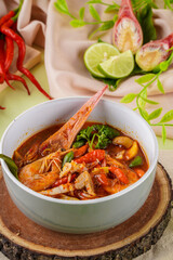 Tom yum or tom yam is a type of hot and sour Thai soup, usually cooked with shrimp (prawn). Tom yum has its origin in Thailand.