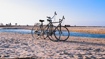 Fototapeta premium Two Bikes on Seashore Beach Sand