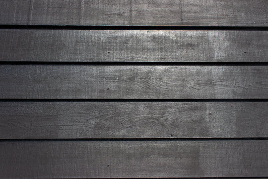 Black painted old wooden wall made out of planks